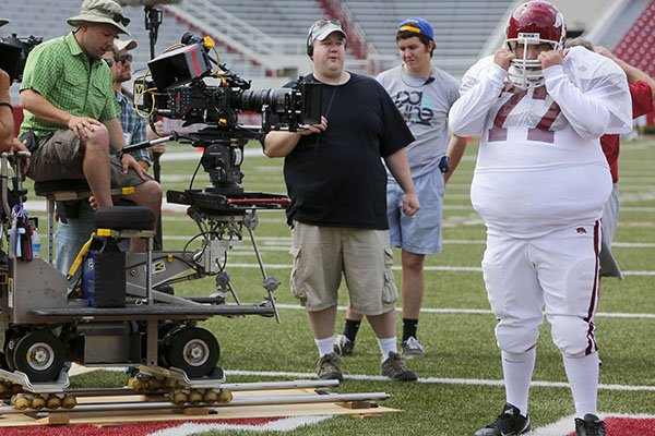 Director David Hunt (center) discusses the camera angle as actor Chris Severio, portraying former University of Arkansas football player Brandon Burlsworth, (right) work during a film shoot Wednesday, May 29, 2013, at Donald W. Reynolds Razorback Stadium in Fayetteville. 