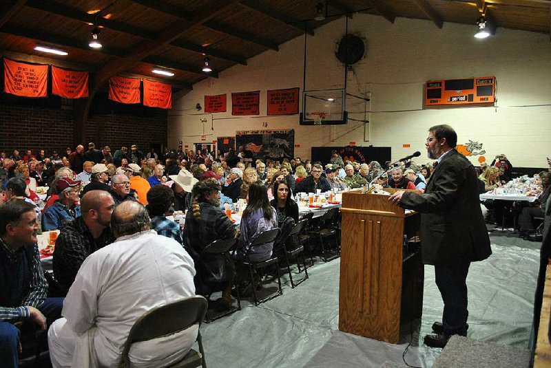 Chad Philipp, president of the Gillett Farmers and Businessmen’s Club, speaks to the crowd Saturday night at the 73rd Gillett Coon Supper. Former U.S. Rep. Marion Berry, who held a pre-supper bash at his farm nearby, said the supper “is just county folks having a good time. That’s what it’s really about.”