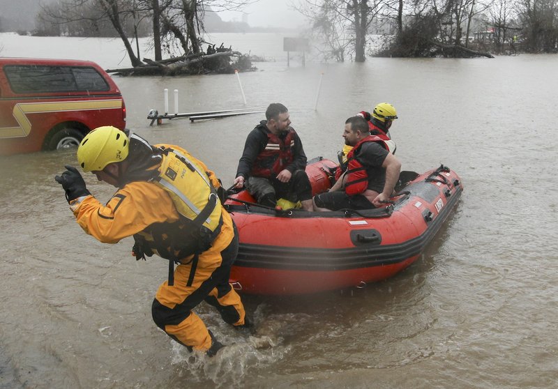 Little Rock firefighters Saturday, Jan. 9, 2016, return to a boat ramp at Burns Park in North Little Rock after rescuing two men who overturned a kayak in the Arkansas River.