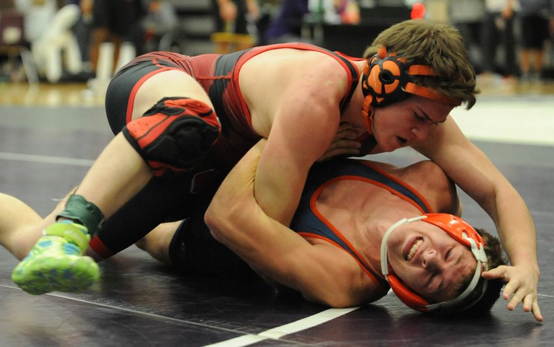 Gaven Long (right) of Rogers Heritage and Justin Vaughn of Searcy wrestle Saturday during the 152-pound championship match. 