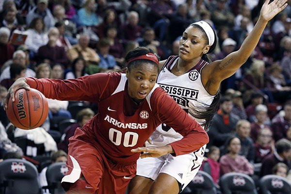 Arkansas forward Jessica Jackson (00) dribbles past Mississippi State forward Victoria Vivians during the first half of an NCAA college basketball game in Starkville, Miss., Sunday, Jan. 10, 2016. Mississippi State won 80-55. (AP Photo/Rogelio V. Solis)
