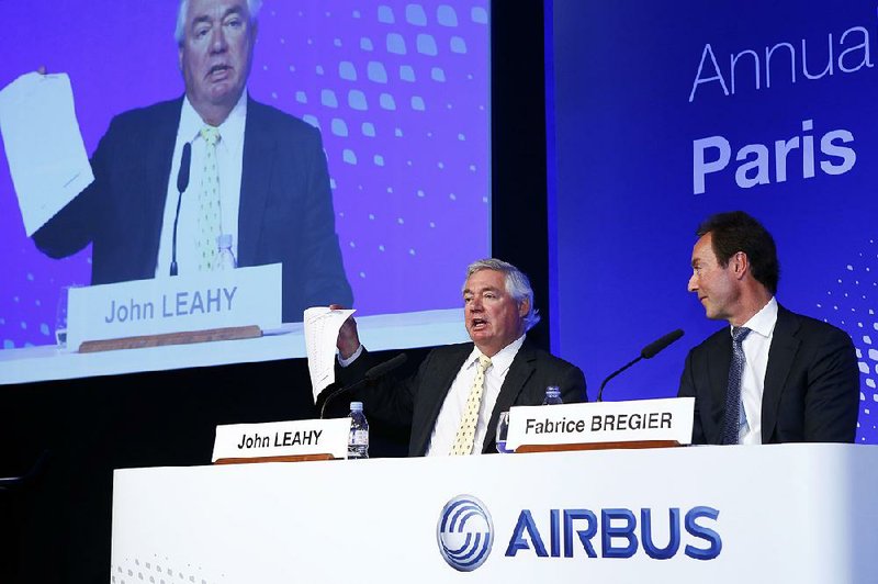 Airbus SA CEO Fabrice Bregier looks on as John Leahy, the aircraft manufacturer’s chief operations officer for customers, displays the company’s 2016 price list on Tuesday during an annual news conference in Paris. 