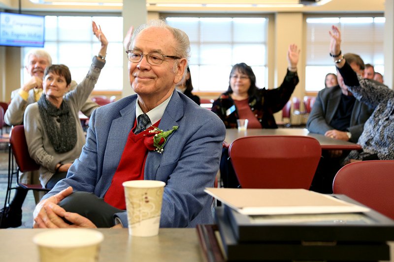With citations and recognitions from members of various levels of government and Arkansas State University System leadership piling up in front of him, Eugene McKay smiles when current and former ASU-Beebe students raise their hands. McKay retired this month from his position as chancellor after 50 years of service in various roles at ASU-Beebe.