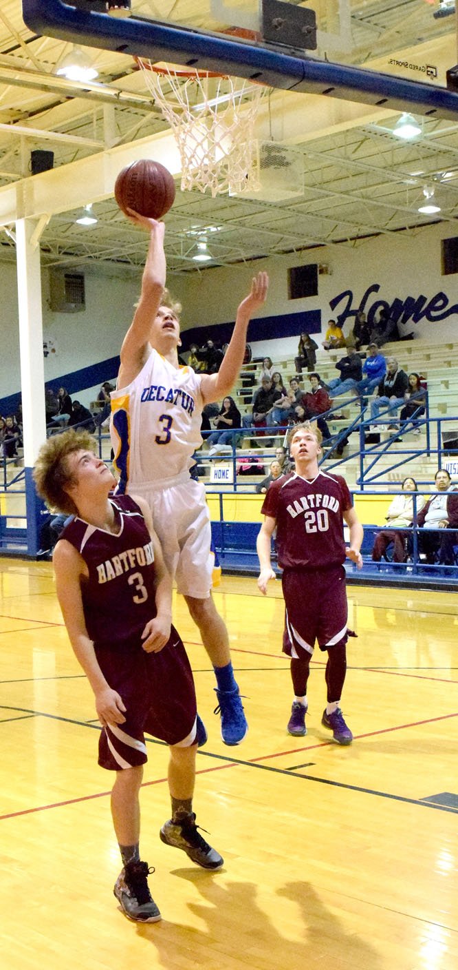 Photo by Mike Eckels Taylor Haisman (Decatur #3) goes for a one-handed layup during the Decatur-Hartford senior boys&#8217; basketball game at Peterson Gym in Decatur Jan. 5. The Bulldogs pulled off their second conference victory by defeating the Beavers, 49 to 41.