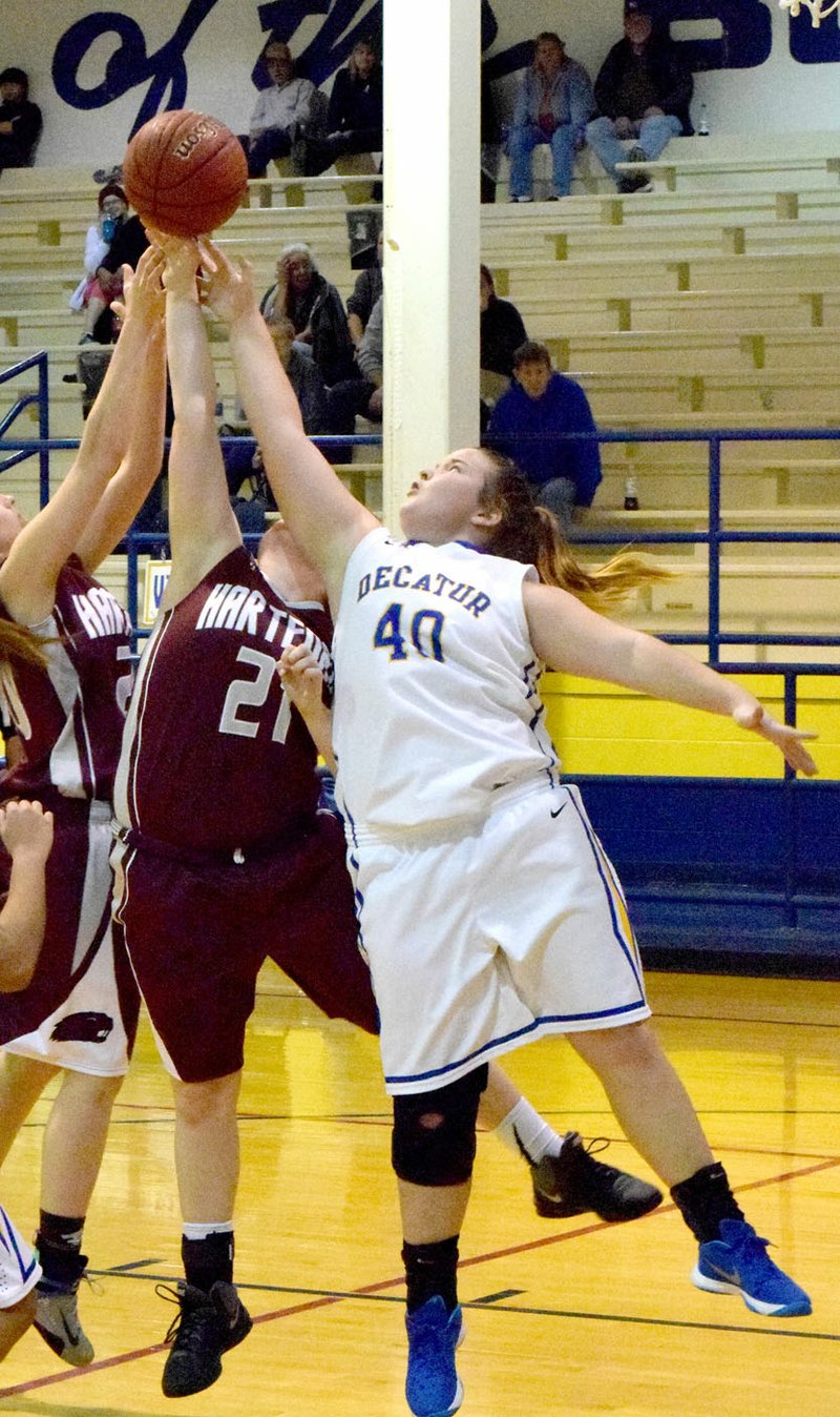 Photo by Mike Eckels Cameron Shaffer (Decatur #40) and two Hartford players fight for control of a rebound during the Jan. 5 Decatur-Hartford game at Peterson Gym in Decatur. The Lady Beavers defeated the Lady Bulldogs, 35 to 21.