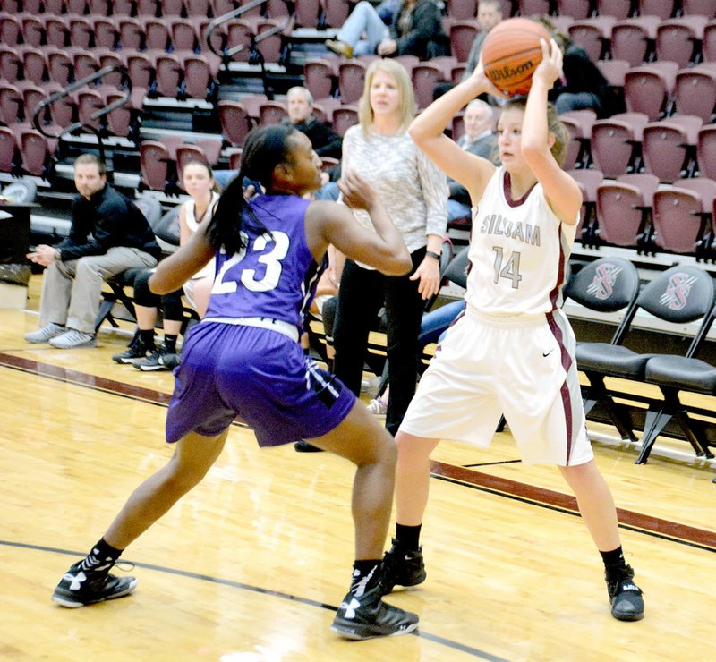 Graham Thomas/Herald-Leader Siloam Springs freshman guard Alexis Roach is guarded by a Fayetteville White defender during Monday&#8217;s game at Panther Activity Center. The Lady Bulldogs defeated the Lady Panthers 33-29.