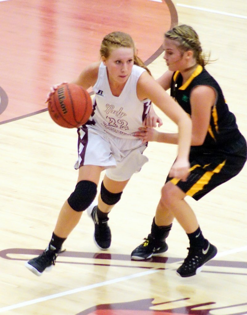 Mallory Morris, a Gentry senior, dribbles past her Prairie Grove defender, Taylor Hartin, during play between the two teams in Gentry on Tuesday, Jan. 12, 2016.