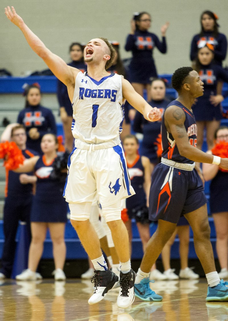 Milacio Freeland, Rogers High senior, celebrates following a Rogers Heritage turnover in overtime on Tuesday, Jan. 12, 2016, at Rogers High.