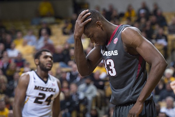 Arkansas’ Moses Kingsley, right, holds his head as Missouri's Kevin Puryear walks in the background, after Kingsley was fouled during the second half of an NCAA college basketball game, Tuesday, Jan. 12, 2016, in Columbia, Mo. Arkansas won the game 94-61. (AP Photo/L.G. Patterson)
