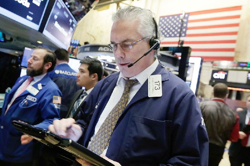 Trader Frank O’Connell works Wednesday on the floor of the New York Stock Exchange. The 2016 sell-off in U.S. stocks intensifi ed, with the Dow Jones industrial average tumbling more than 360 points. 