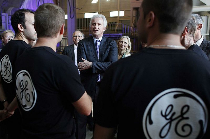 General Electric Co. Chief Executive Officer Jeffrey Immelt (center) speaks with workers at the GE plant in Belfort, France, during a 2014 visit. 