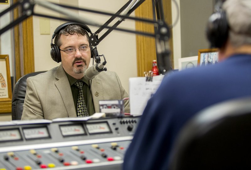 Benton County Sheriff Kelley Cradduck speaks Wednesday to Kermit Womack at KURM radio in Rogers. Cradduck addressed grievances filed against him as sheriff. “They’re peppering me with them to give the impression things are not going well with the Sheriff’s Office. Things have never been better.”