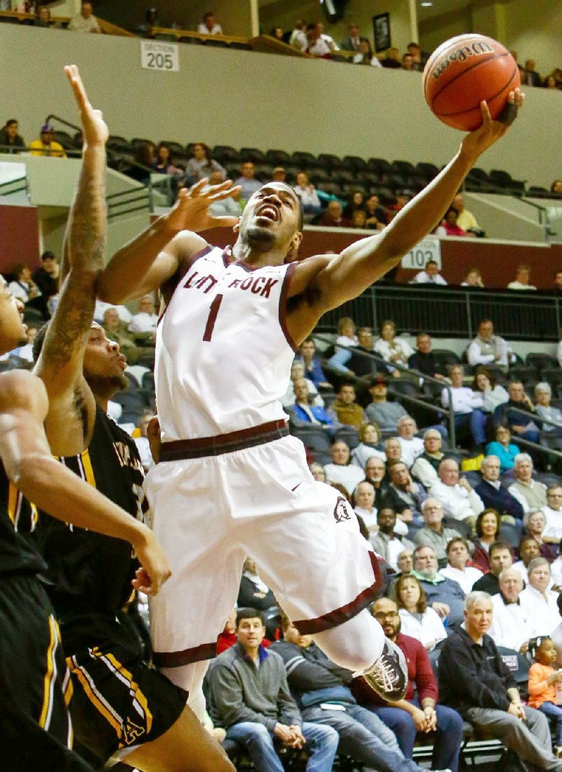 UALR forward Jalen Jackson (1) goes up for a shot around Appalachian State defenders during Thursday night’s game at the Jack Stephens Center in Little Rock. Jackson fi nished with 16 points and seven rebounds to help the Trojans stay unbeaten in Sun Belt Conference play with an 81-55 victory.