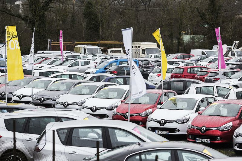 Automobiles are parked on the lot of a Renault SA automobile dealership in Rodez, France, on Wednesday. Renault offices in France were searched by government fraud investigators as part of an investigation into vehicle emissions.