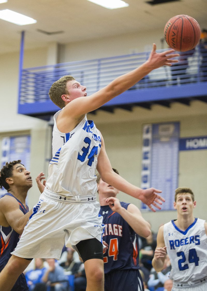 Rogers High senior Will Allen scoops the ball to the basket on Tuesday, Jan. 12, 2016, against Rogers Heritage at Rogers High. 