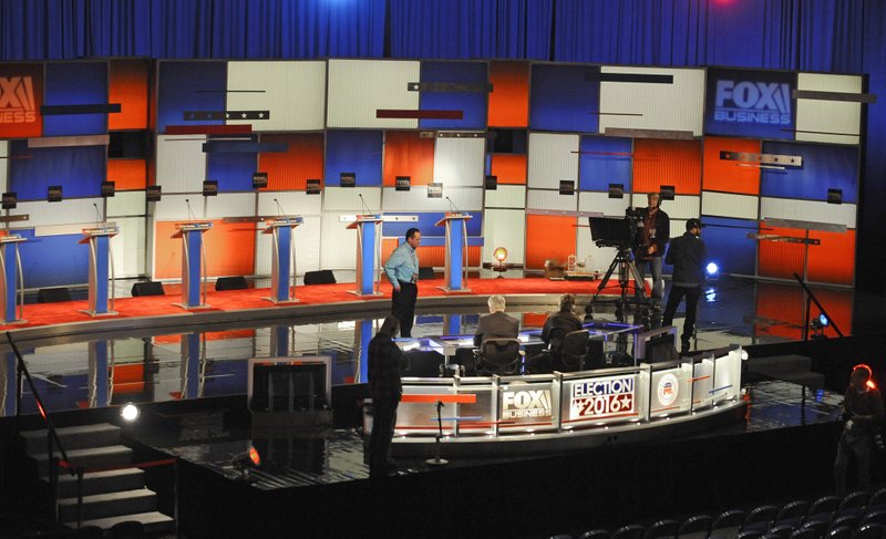 Crew members set the stage at the North Charleston Coliseum, Wednesday, Jan. 13, 2016, in North Charleston, S.C., in advance of Thursday's Fox Business Network Republican presidential debate. (AP Photo/Rainier Ehrhardt)