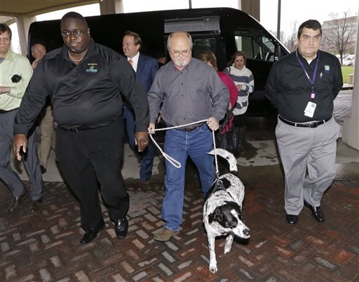 John Robinson, center, of Munford, Tenn., arrives with his dog at the Tennessee Lottery headquarters Friday, Jan. 15, 2016, in Nashville, Tenn. 