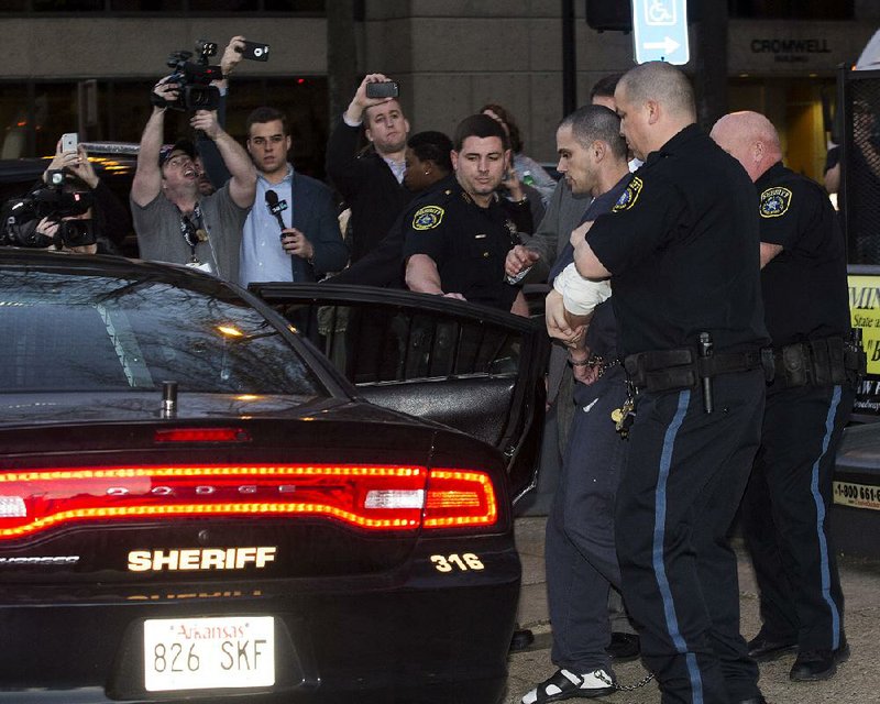 FILE — Arron Lewis is taken away from the Pulaski County Courthouse on January 15, 2016 under heavy guard and heavy media coverage.