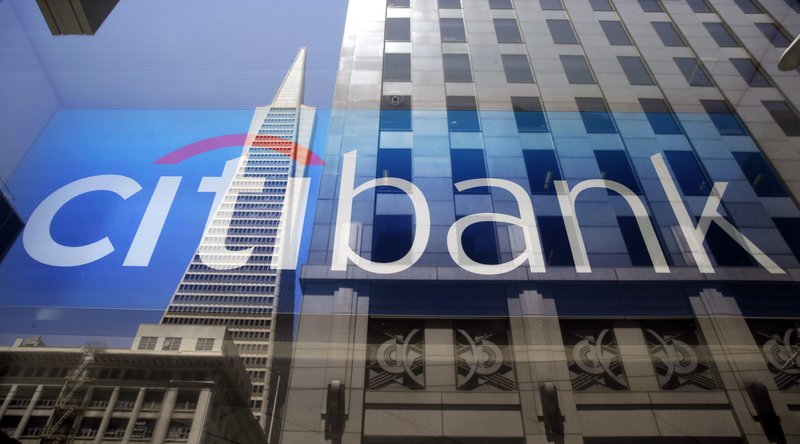 The Transamerica Pyramid is reflected in the window of the main branch of Citibank in the Financial District of San Francisco. Citigroup reports quarterly financial results Friday, Jan. 15, 2016. (AP Photo/Eric Risberg, File)