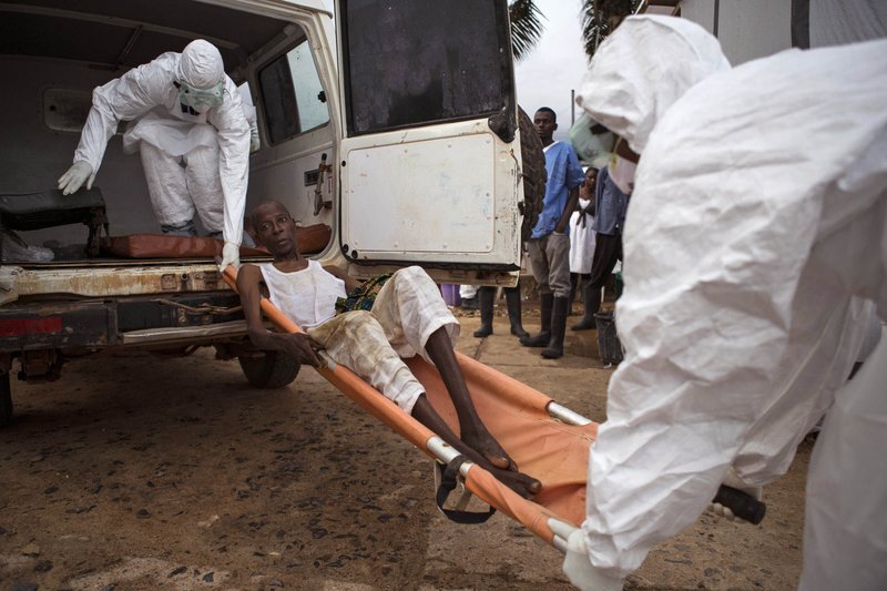 Healthcare workers load a man suspected of suffering from the Ebola virus onto an ambulance in Kenema, Sierra Leone. A corpse has tested positive for Ebola in Sierra Leone, an official said Friday, Jan. 15, 2016, the day after the World Health Organization declared the outbreak over in West Africa. (AP Photo/ Tanya Bindra,File)