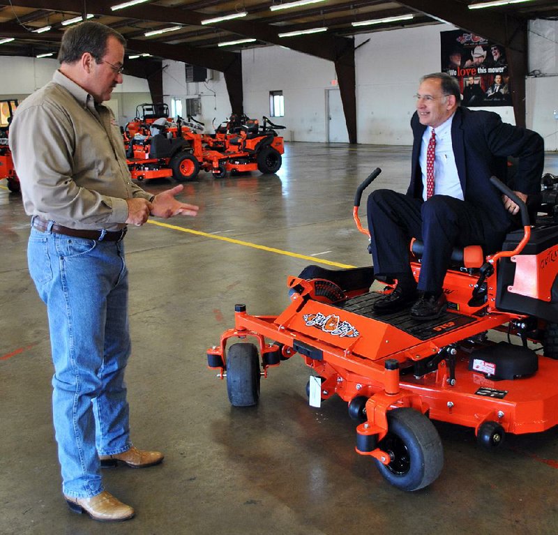 Scott Lancaster (left), general counsel for Bad Boy Mowers in Batesville, discusses the company’s products with U.S. Sen John Boozman. The company has received millions of dollars in incentives from the Arkansas Economic Development Commission. 