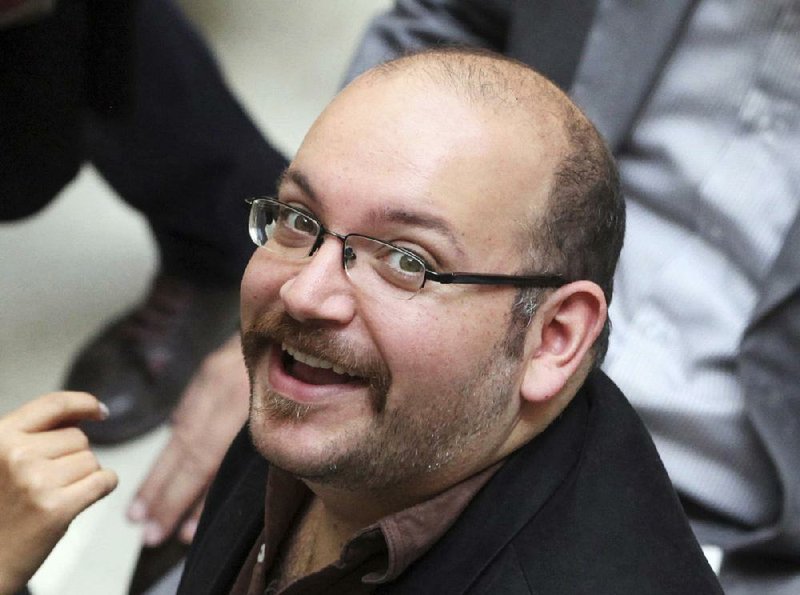  In this April 11, 2013 file photo, Jason Rezaian, an Iranian-American correspondent for the Washington Post, smiles as he attends a presidential campaign of President Hassan Rouhani in Tehran, Iran. Iran state television has reported that the government has released several dual-national prisoners. 