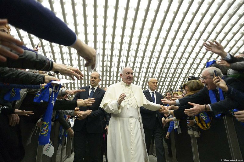 Pope Francis is cheered Saturday as he arrives for a special audience with members of Italy’s Christian Workers’ Movement in the Paul VI Hall at the Vatican. 