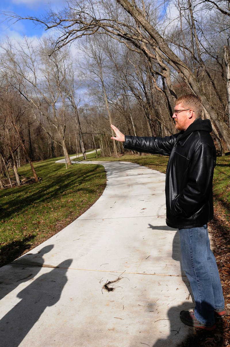 David Hook, director of facilities and development, looks Friday at one of his favorite sections of completed trail near Lake Atalanta. The section meanders from Pleasant Ridge Road to the lake.