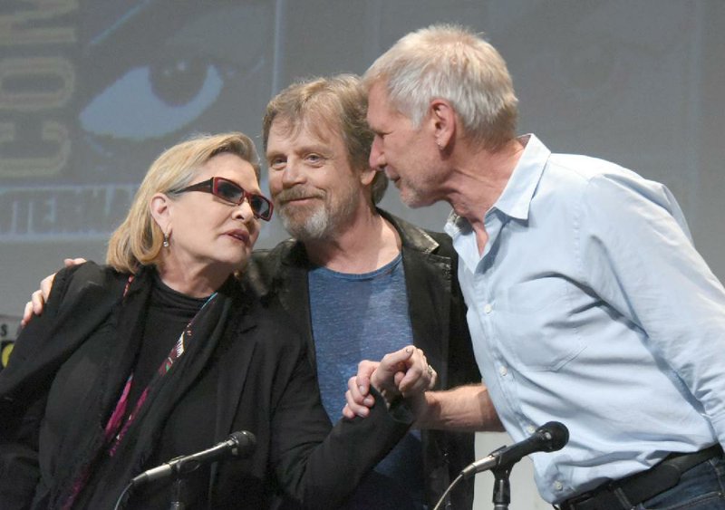 Carrie Fisher, from left, Mark Hamill, and Harrison Ford attend Lucasfilm's "Star Wars: The Force Awakens" panel on day 2 of Comic-Con International in San Diego, Calif. 