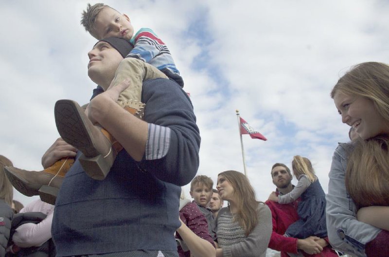 Mark Dominguez (left) listens to speakers during the 2016 March for Life rally at the state Capitol on Sunday. Dominguez went to the rally with his son Khai, 5, and with other relatives and friends in support of anti-abortion activists.