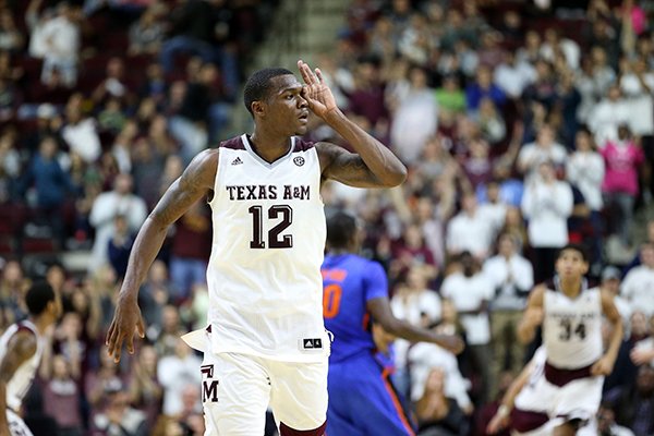 Texas A&M's Jalen Jones (12) makes a three point gesture over his eye after hitting a three point basket at the buzzer of the first half of an NCAA college basketball game against Florida, Tuesday, Jan. 12, 2016, in College Station, Texas. (AP Photo/Sam Craft)
