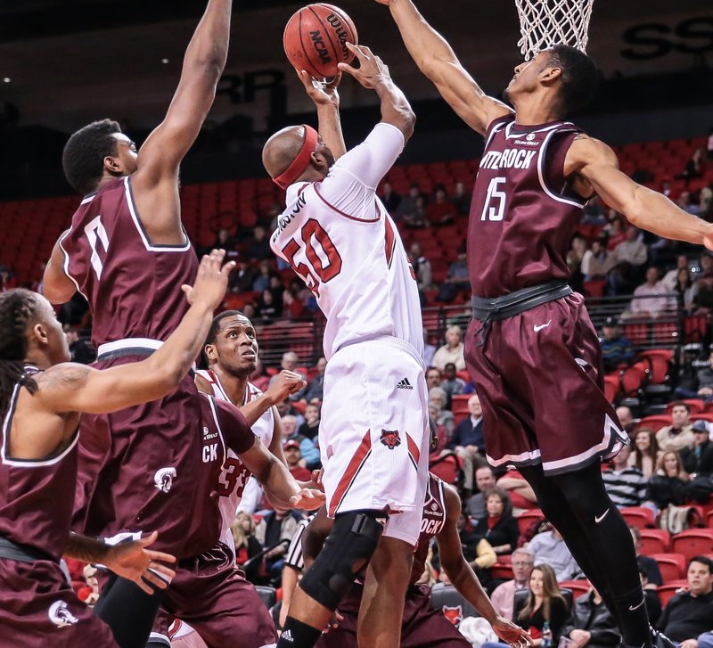 Arkansas State forward Anthony Livingston (50) goes up for a shot between several UALR defenders in Monday’s game. ASU led by 18 points at halftime, but had to hold on for a 76-73 victory.