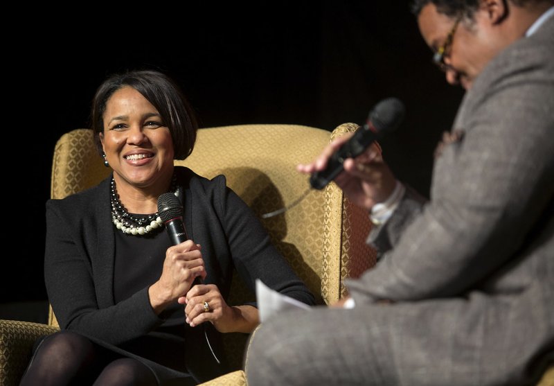 Rosalind Brewer, Sam’s Club president and chief executive officer, talks Monday with Tony Walker with the Northwest Arkansas Martin Luther King Jr. Council on stage during the annual Dr. Martin Luther King Jr. Community Re-commitment Banquet at Fayetteville’s Town Center.