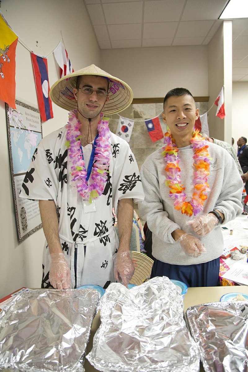 Senior Airman Ada Oliveria, left, and Airman 1st Class Kelvin Chien serve food at the Asian American and Pacific Islander Heritage booth at the Little Rock Air Force Base Diversity Day.