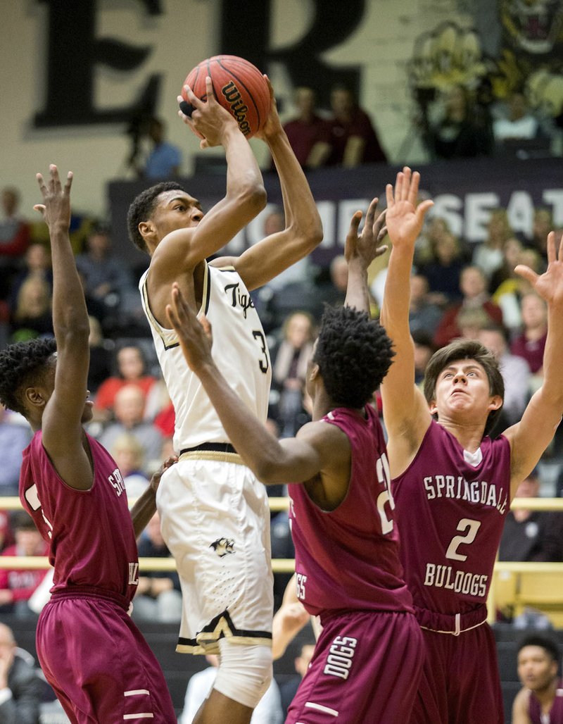 Jordan Hemphill, Bentonville junior, shoots Tuesday against Springdale High in Bentonville.