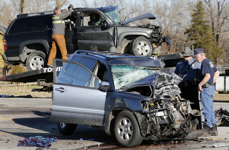 Two vehicles are prepared for towing Jan. 12 following a crash on U.S. 412 in front of Sonora Middle School near Springdale. Jeremy White, 31, of Springdale was killed in the accident, according to the Arkansas State Police.