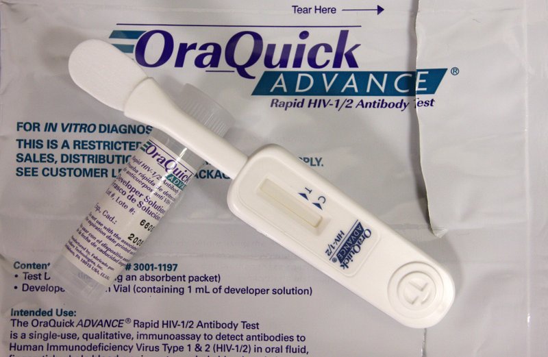 This June 26, 2008, file photo shows a developer solution vial (left) and test device (right) for an oral rapid HIV test at a medical center in the Bronx borough of New York. 