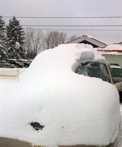 This Tuesday, Jan. 19, 2016, photo provided by the Ontario Provincial Police shows a snow-covered vehicle in Brussels, Ontario.