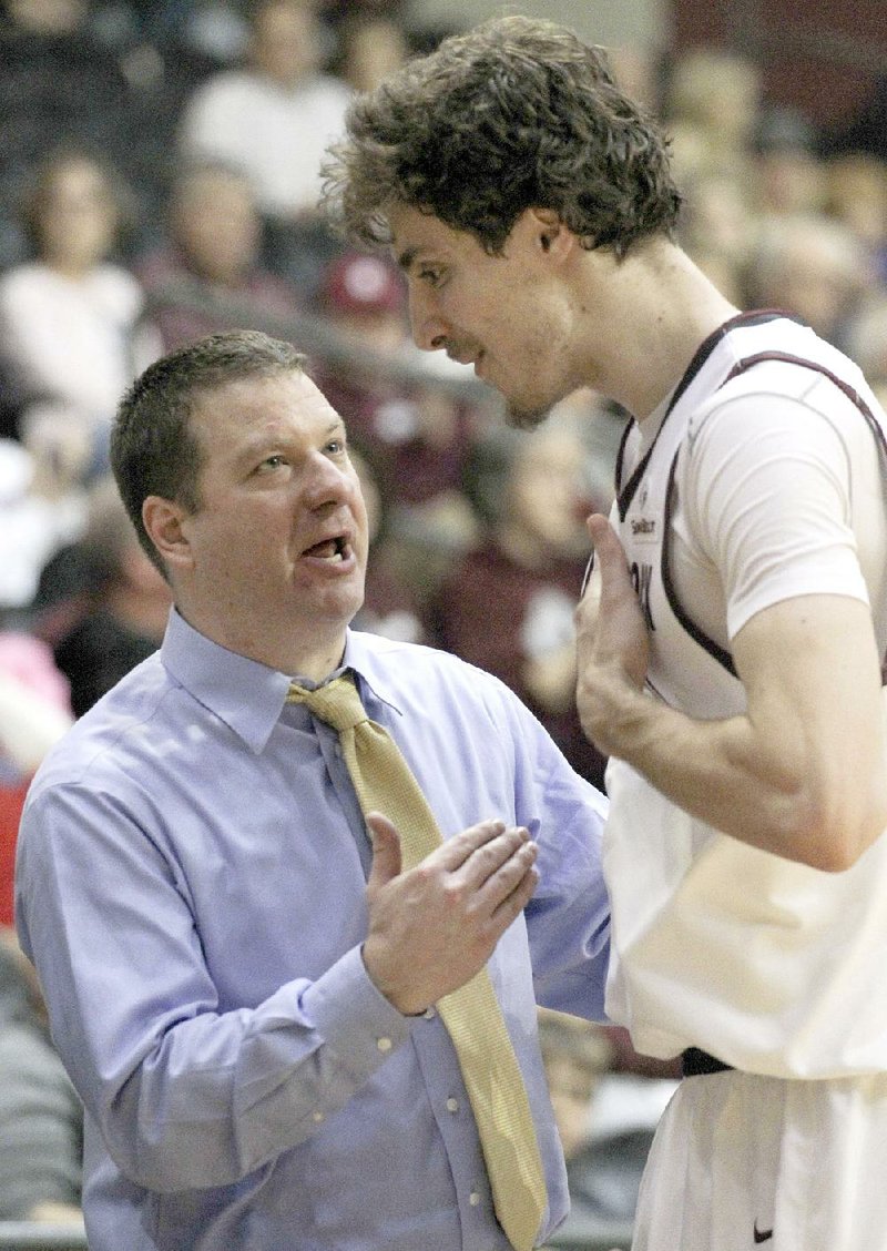 UALR men’s Coach Chris Beard (left) talks with forward Lis Shoshi during a game earlier this season in Little Rock. Beard has considered changing his starting lineup, which has stayed the same for 17 games this season. 