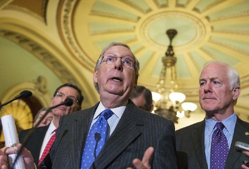 Senate Majority Leader Mitch McConnell, R-Ky., (center) joined by Majority Whip John Cornyn, R-Texas, speaks with reporters Wednesday just before Democrats blocked a bill to tighten controls on Syrian and Iraqi refugees entering the U.S. 