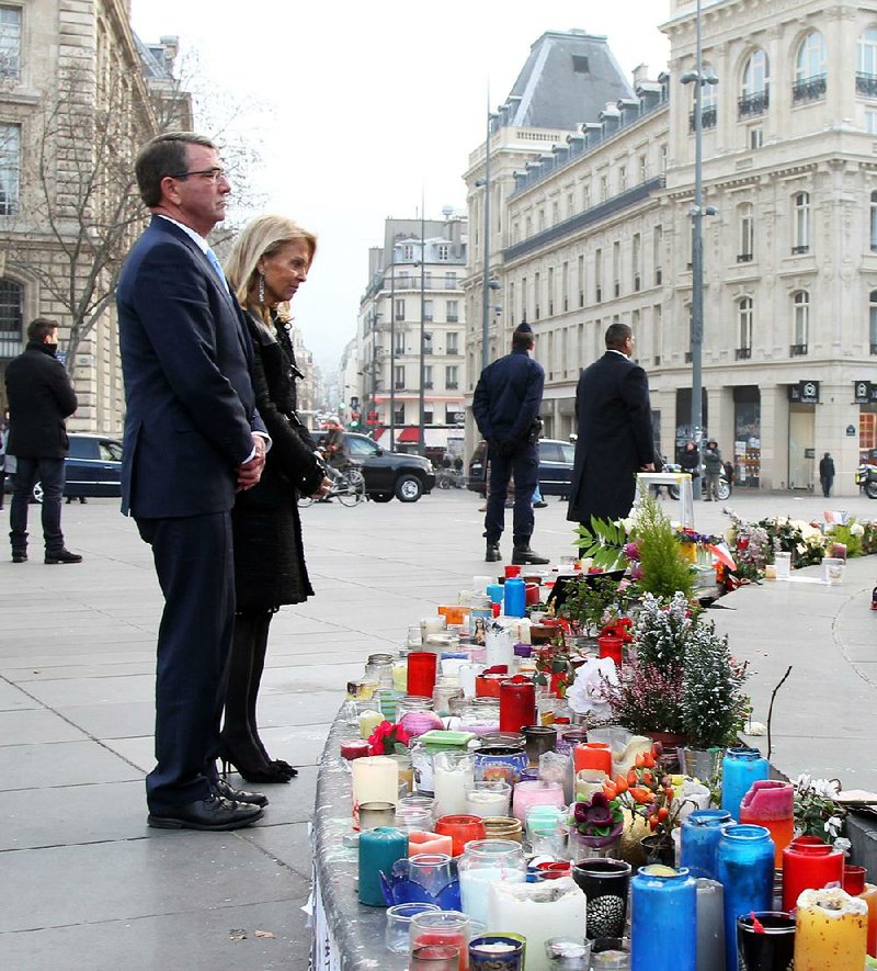 Defense Secretary Ashton Carter and U.S. Ambassador to France Jane Hartley stand Wednesday in Paris at a memorial to those killed in terrorist attacks in France. In talks with defense ministers, Carter laid out U.S. plans for a coordinated campaign against Islamic State militants. 