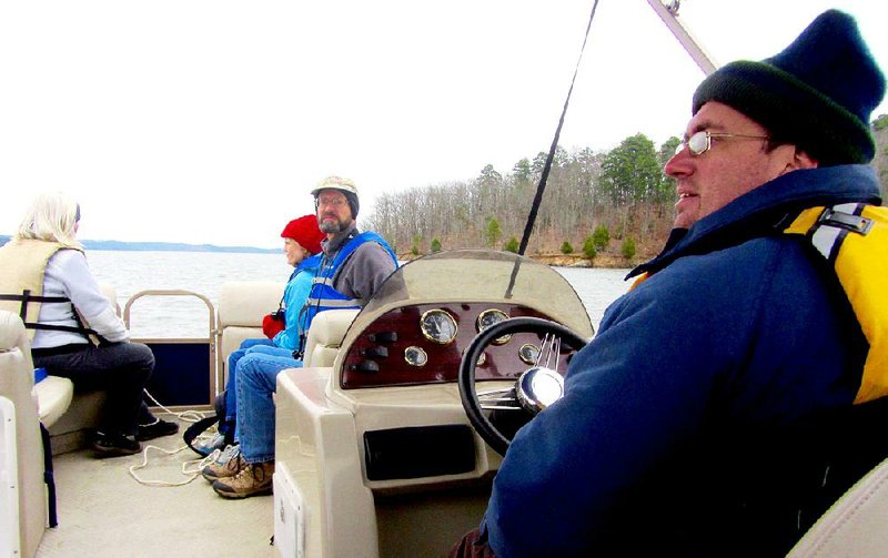 Passengers taking an Eagle Lake Cruise on Lake Maumelle listen to Richard Spilman, an interpreter at Pinnacle Mountain State Park. 