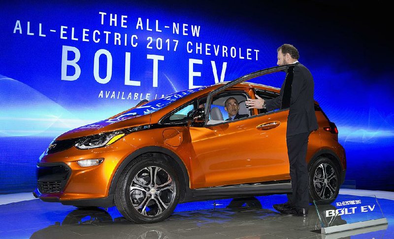 President Barack Obama sits in a new Chevrolet Bolt electric car Wednesday at the 2016 North American International Auto Show in Detroit. 