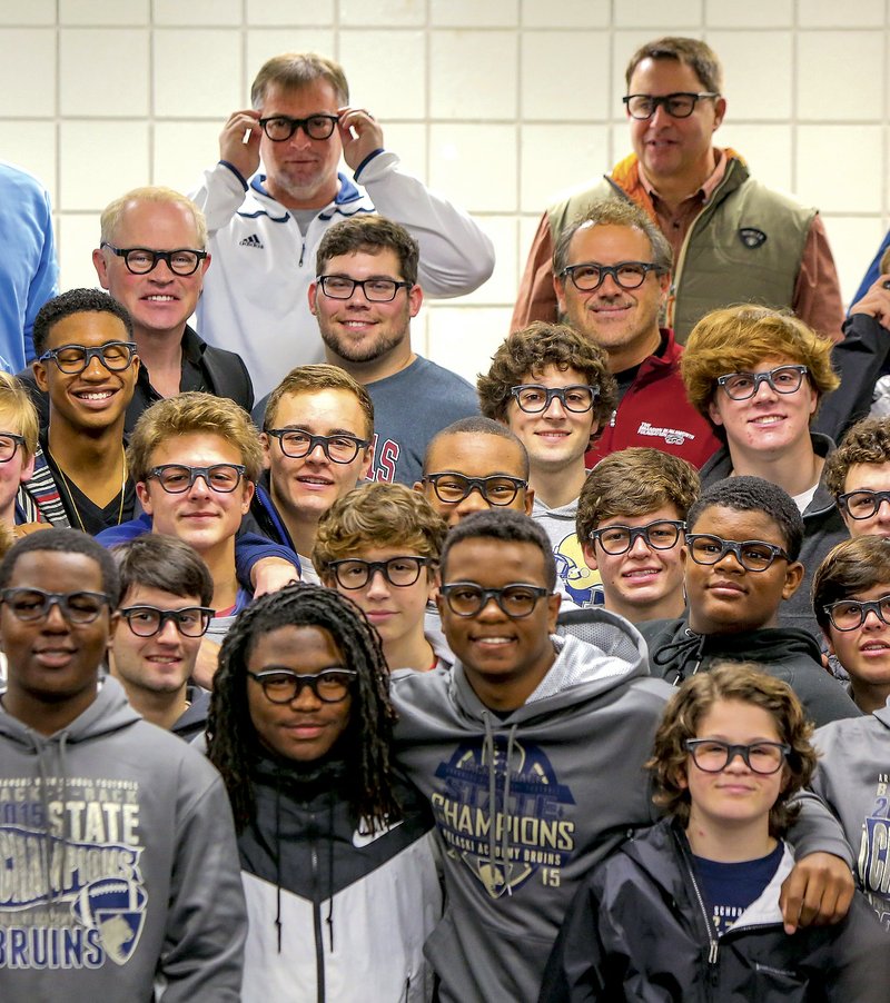 Members of the Pulaski Academy football team pose wearing Brandon Burlsworth-style glasses after watching a trailer for the new film Greater, depicting Burlsworth’s life at the Little Rock school. The movie’s producer Brian Reindl, is top right. In the next row at left is actor Neal McDonough who plays Marty Burlsworth. At center is actor Chris Severio who portrays Brandon Burlsworth. To his right is Marty Burlsworth, Brandon’s brother.