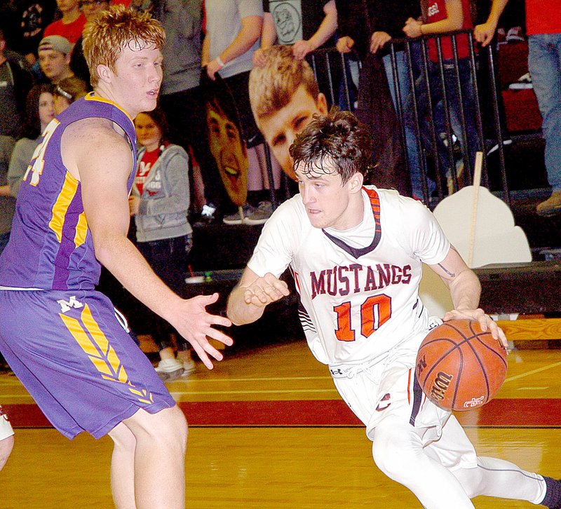 Photo by Rick Peck McDonald County&#8217;s Dagan Stites drives past Monett&#8217;s Kobe Besch for two of his 11 points during the Mustangs 61-33 win on Jan. 12 at MCHS.