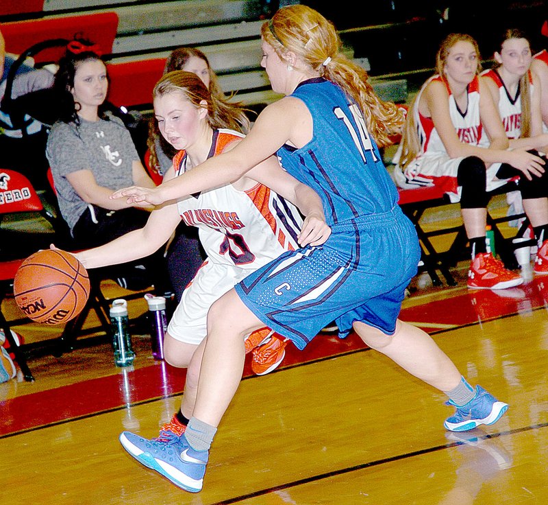 Photo by Rick Peck McDonald County&#8217;s Cloee Helm drives around Carthage&#8217;s Taylor Stanley during the Lady Tigers 52-41 win on Jan. 15 at MCHS.