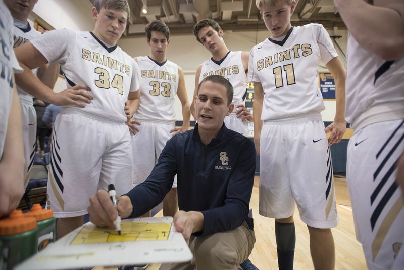 Shiloh Christian boys coach Jacob Skinner talks strategy with his squad Jan. 12 during a timeout. Skinner is a former Arkansas Razorbacks punter.