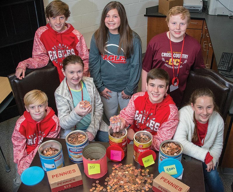 Vilonia Middle School seventh-graders show some of the pennies they have collected so far for their One Cent, One Life project. The students, members of Linda Knapp’s Pre-AP literacy class, have a goal of 6 million pennies to represent the Jews killed in the Holocaust. Students participating include, seated, from left, Ty Heslep, Hannah Johnson, Gabriel Goodwin and Emma Duncan; and standing, Tate Smithhart, Grace Shannon and Lucas Yarbrough.