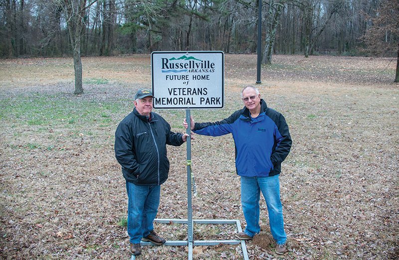 Russ Hall, left, vice chairman of the River Valley Veterans Coalition, and Bill Eaton, treasurer of the coalition, stand by the sign on the site of the future Veterans Memorial Park at the Bona Dea Trails and Sanctuary in Russellville. The coalition represents five federally chartered veterans organizations in Russellville.