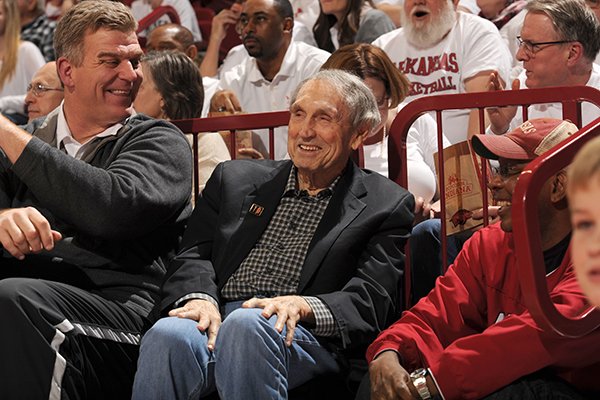 Former Arkansas basketball coach Eddie Sutton, center, talks with former players Joe Kleine, left, and Darrel Walker, right, during a game between Arkansas and Kentucky on Thursday, Jan. 21, 2016, at Bud Walton Arena in Fayetteville.
